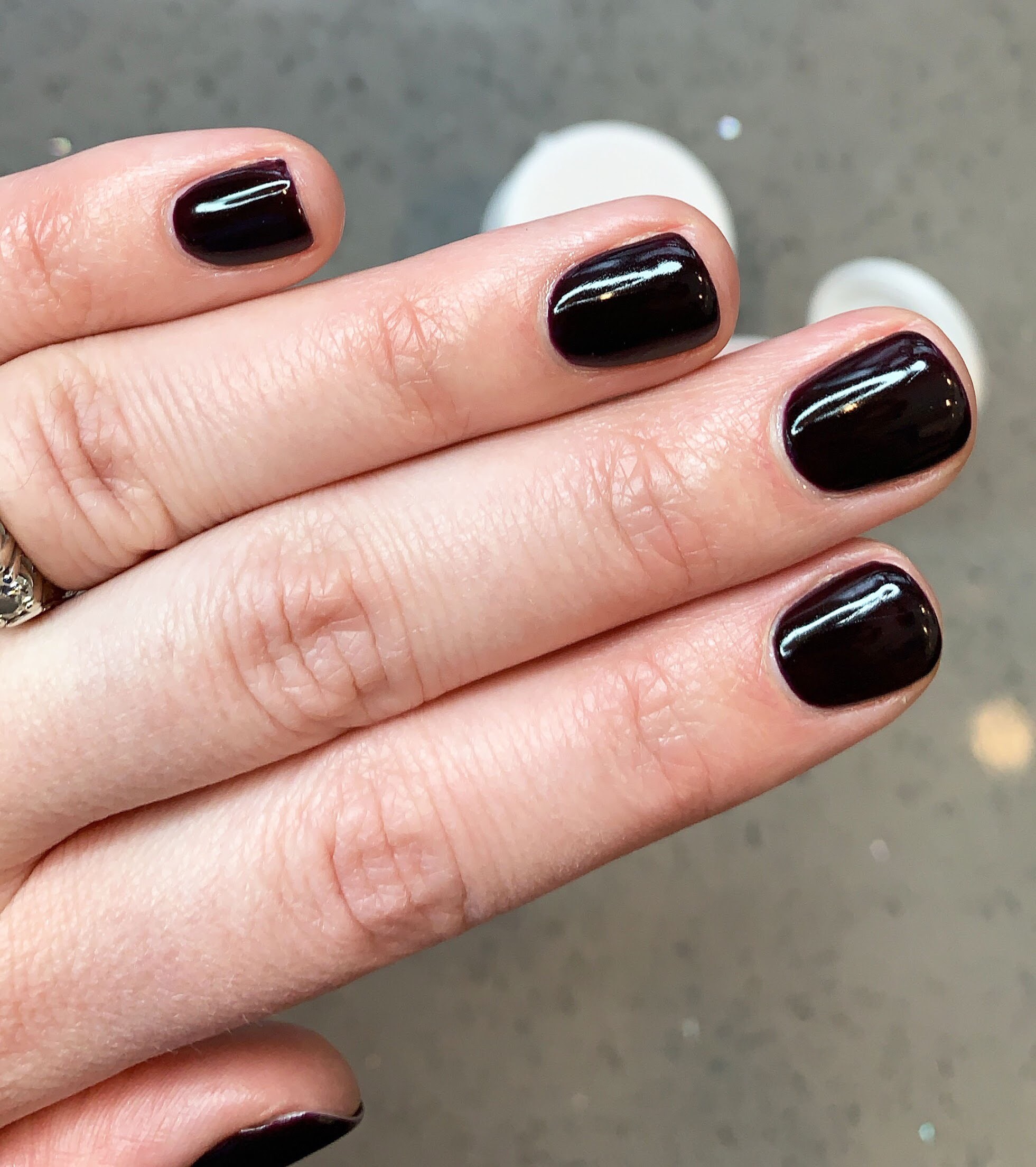 Dark nail colour and short manicured fingers 